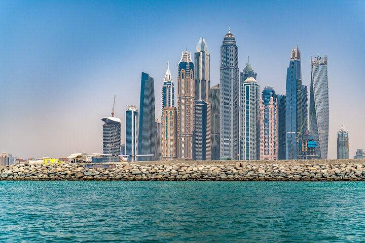 Explore Dubai's skyline with its stunning skyscrapers and iconic landmarks. Experience the blend of modern architecture and luxurious living as you cruise past shimmering waters. Uncover the city’s unique beauty!